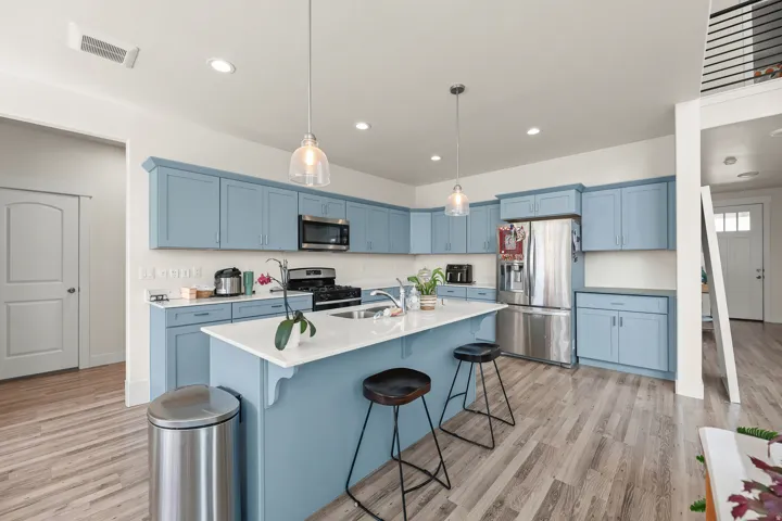 Kitchen featuring light blue cabinetry, stainless steel appliances(all included)