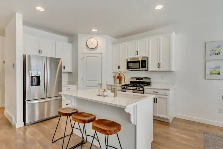 White cabinetry and island with a white countertop