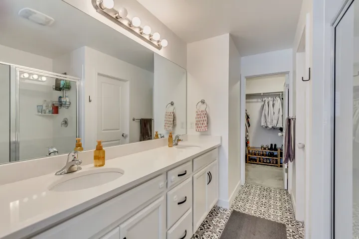 Dual vanity with undermount sinks, stone countertop, and brushed nickel fixtures