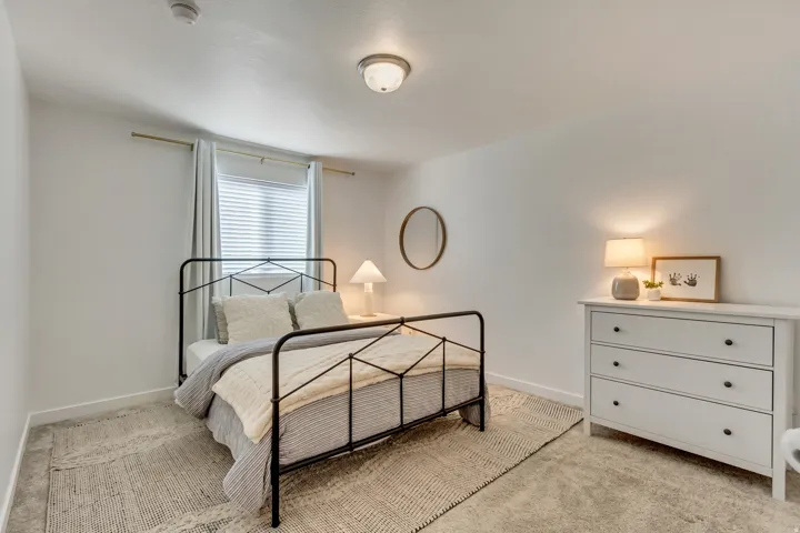 White walls, window with blinds and drapes, and flush-mount ceiling light