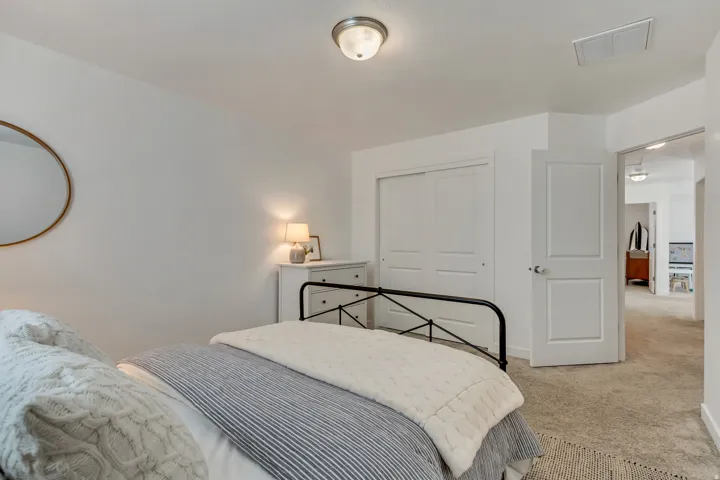 Recessed ceiling light fixture, white interior door, and light-colored carpeting
