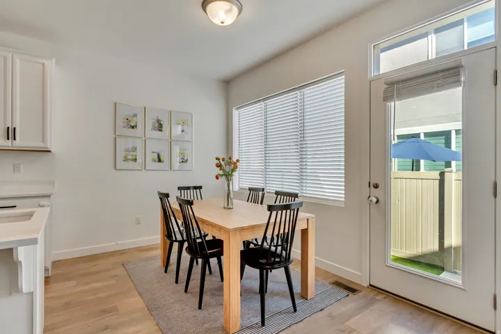 Light wood-finish flooring with white walls and trim