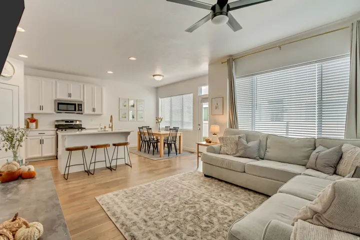 Open-concept living space featuring a kitchen, dining area, and living room