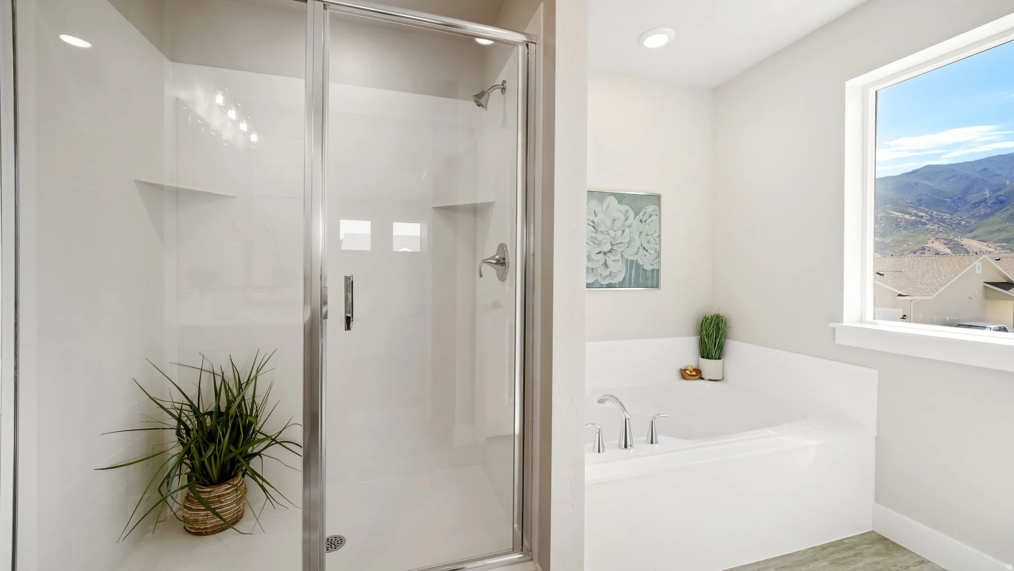 Walk-in shower with clear glass enclosure and recessed lighting