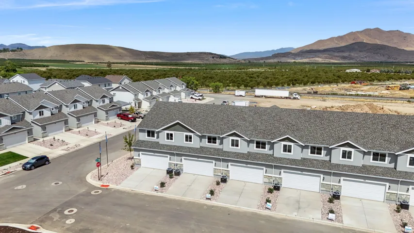 Modern townhome community featuring a uniform architectural style and attached garages
