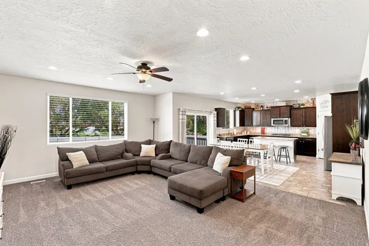 Open-concept living space featuring recessed lighting and a ceiling fan