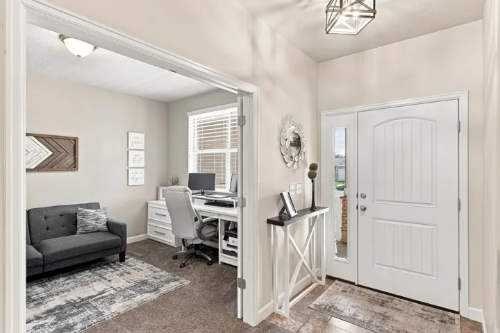 Double entry doors with an arched panel design and frosted glass sidelight