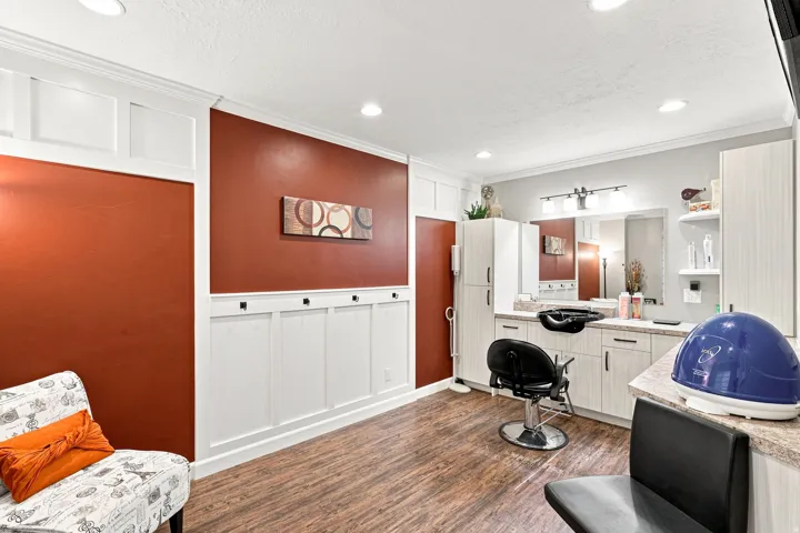 Wood-finish flooring, recessed lighting, and wall paneling