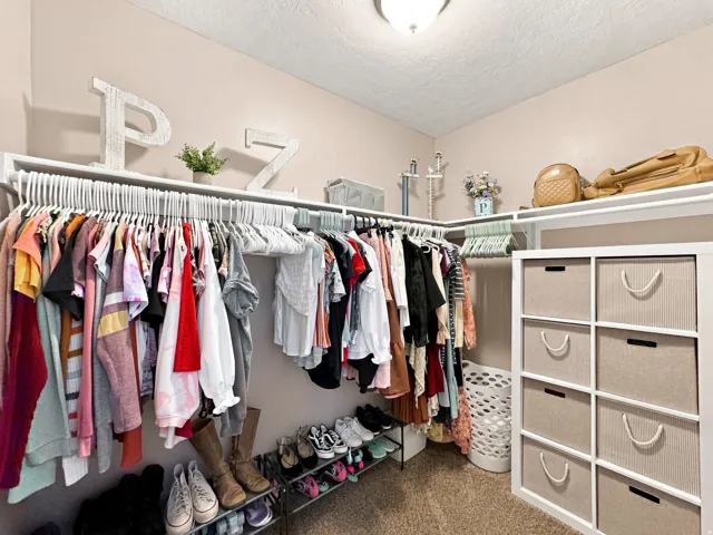 Wall-mounted closet organization system featuring shelving and hanging rods