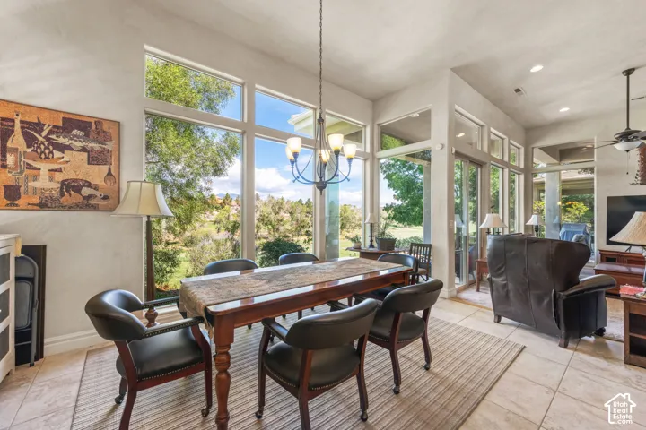 High ceilings with recessed lighting, tile flooring, and expansive windows