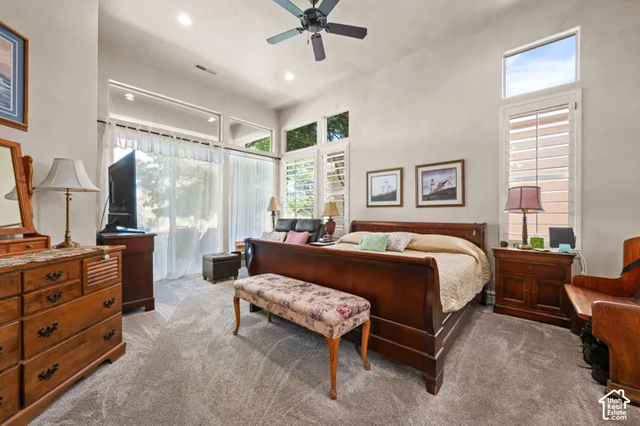 Vaulted ceiling with recessed lighting and a ceiling fan