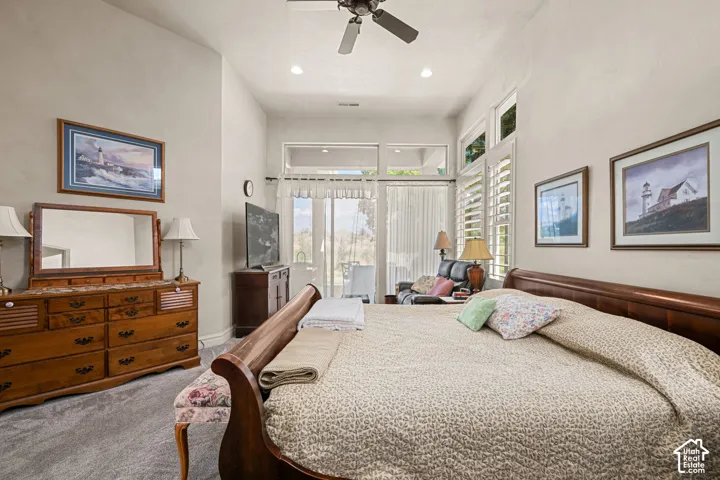 Vaulted ceiling with a ceiling fan, recessed lighting, and large windows with plantation shutters