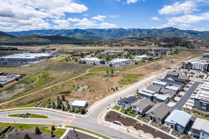 New residential development with modern architectural styles, paved roadways, and integrated landscaping