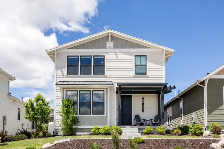 Two-story residence featuring siding and shingle accents