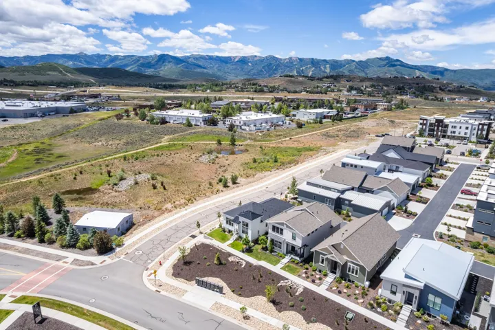 Mountain backdrop with established residential properties and developed commercial areas