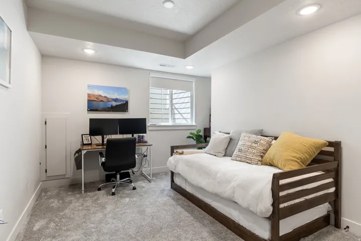 Recessed lighting, wall-to-wall carpeting, and a window with blinds