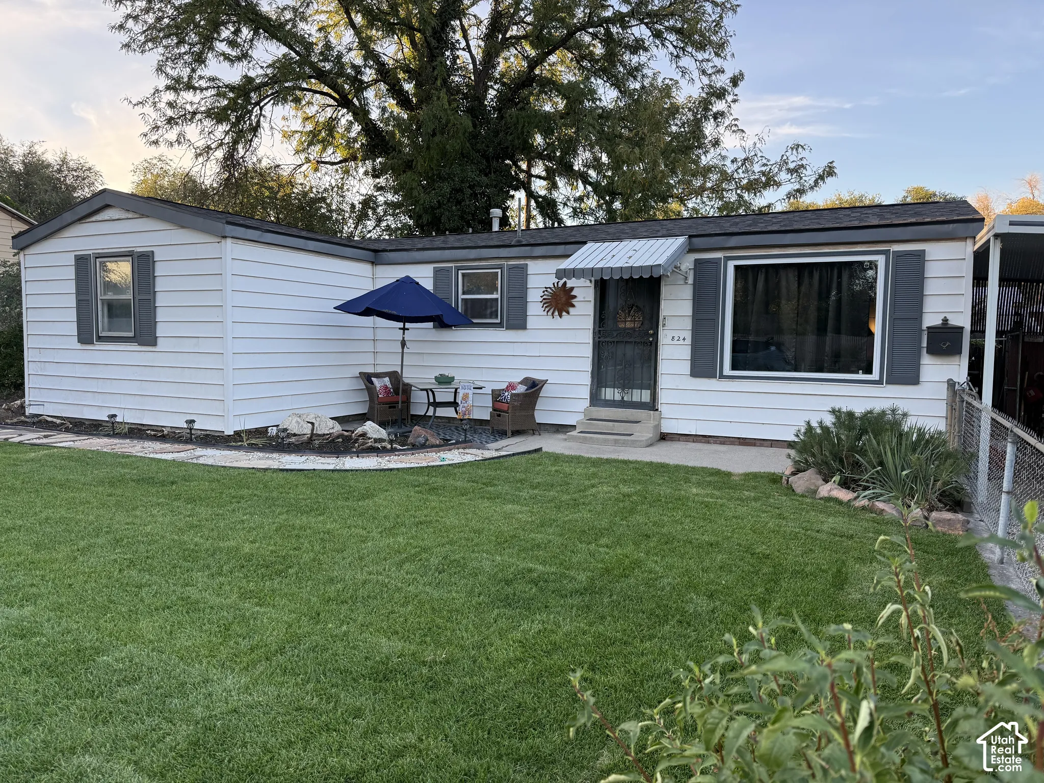 White siding exterior with dark gray trim and a shingled roof