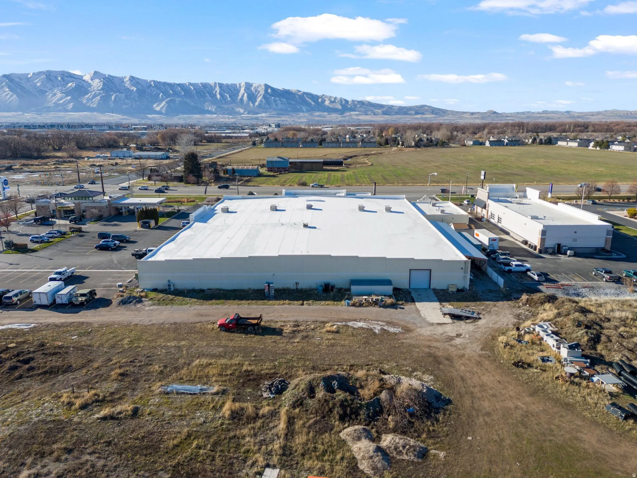 Expansive commercial property featuring multiple structures and ample parking