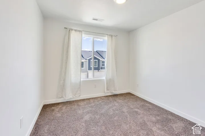 Recessed ceiling light, neutral wall paint, carpeted flooring, large window, window curtains