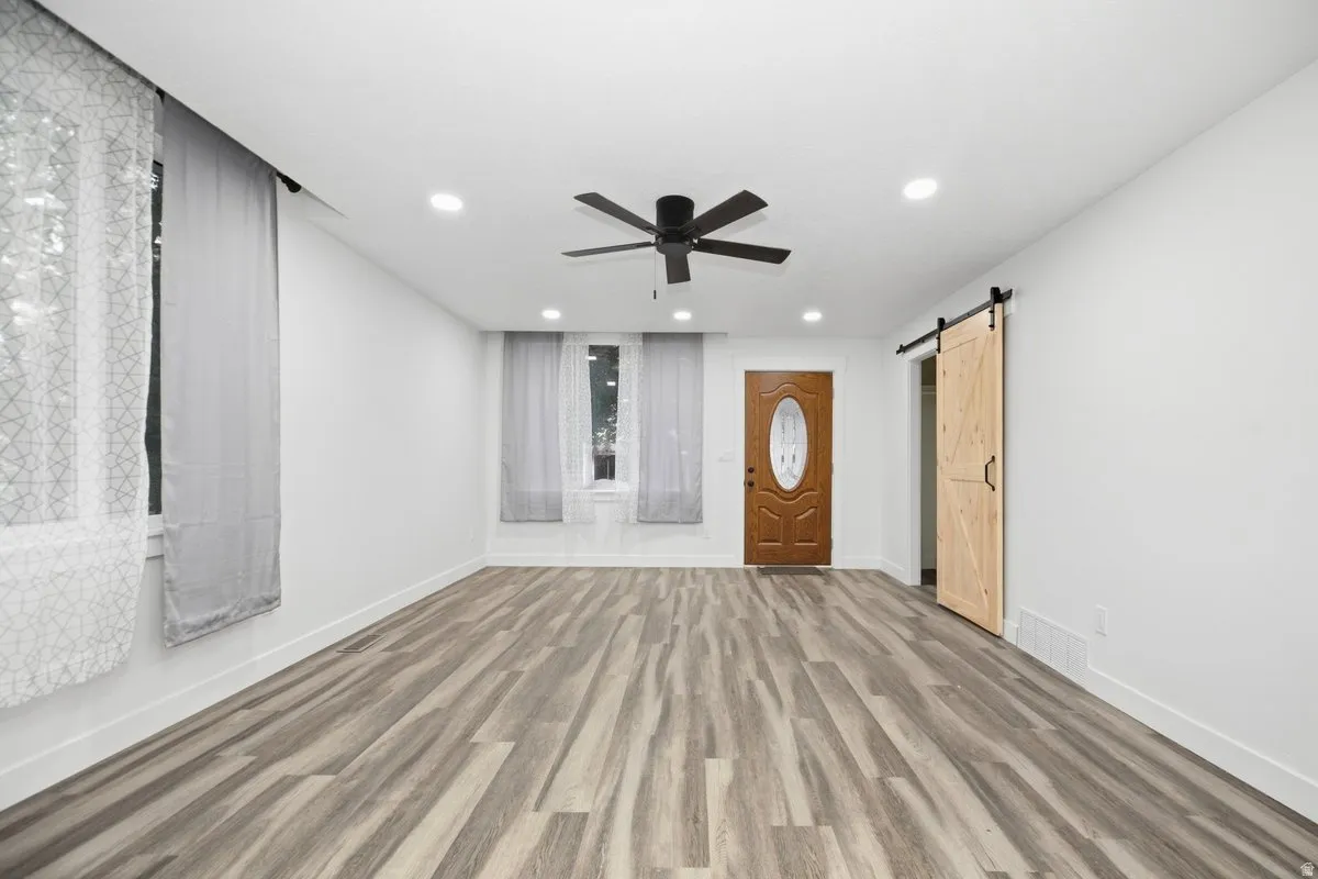 Wood-finish flooring, recessed lighting, and a ceiling fan