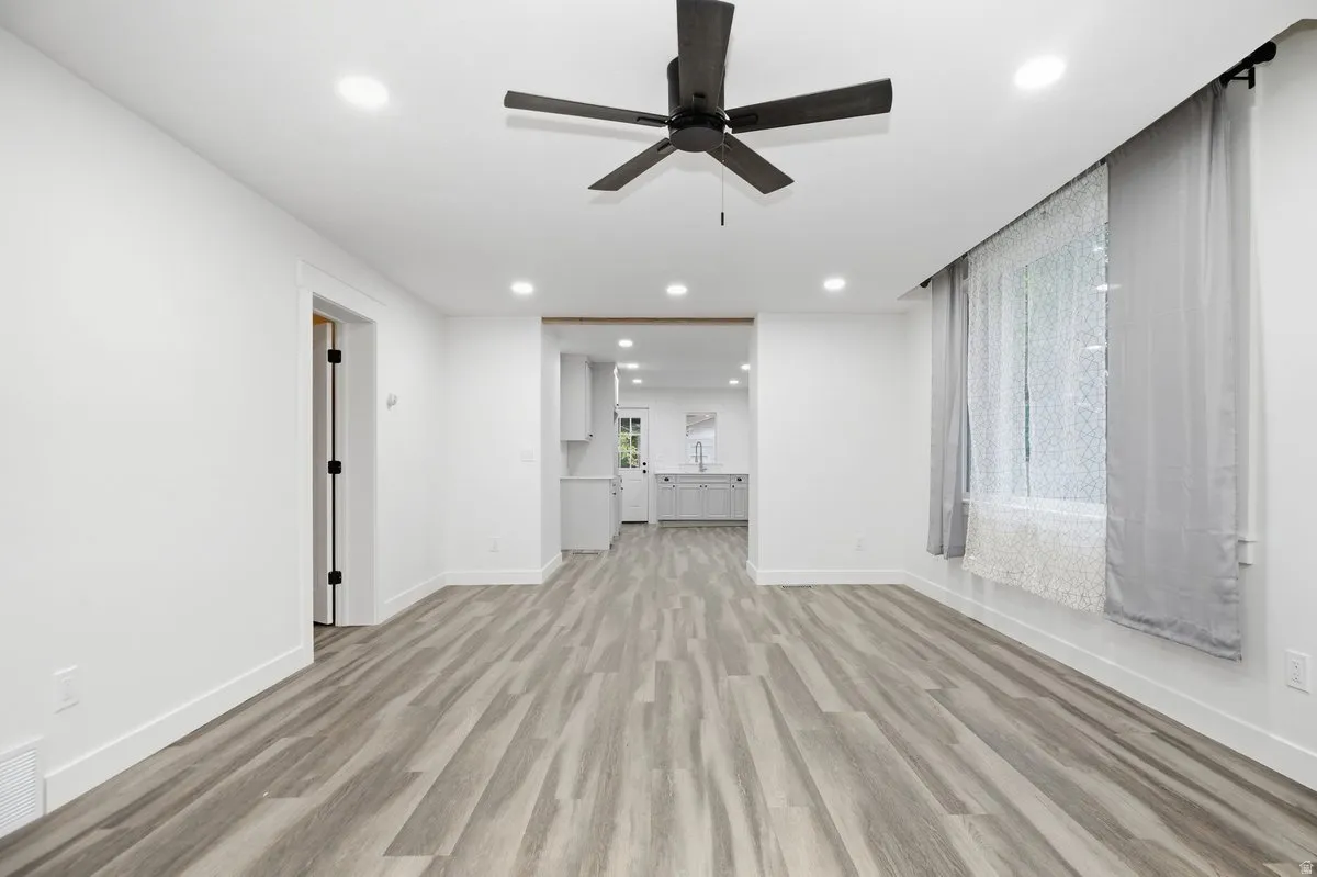 Wood-finish flooring throughout, recessed lighting, and a ceiling fan