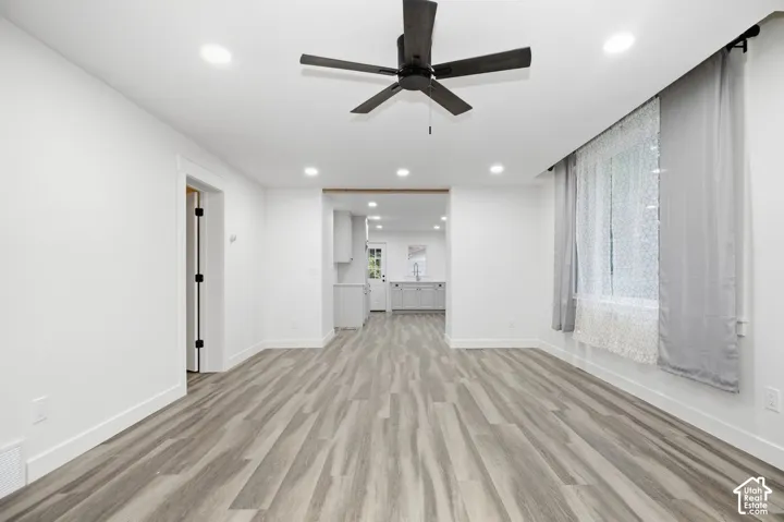 Wood-finish flooring throughout, recessed lighting, and a ceiling fan