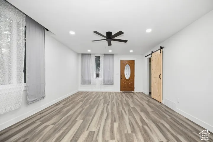 Wood-finish flooring, recessed lighting, and a ceiling fan
