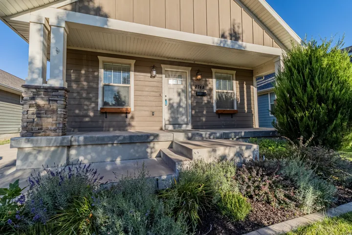 Covered porch with stone-accented pillar and wood-finish window boxes