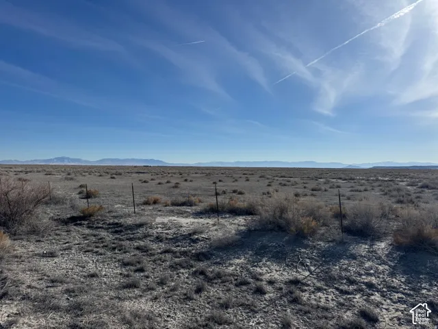 Expansive open land with distant mountain ranges