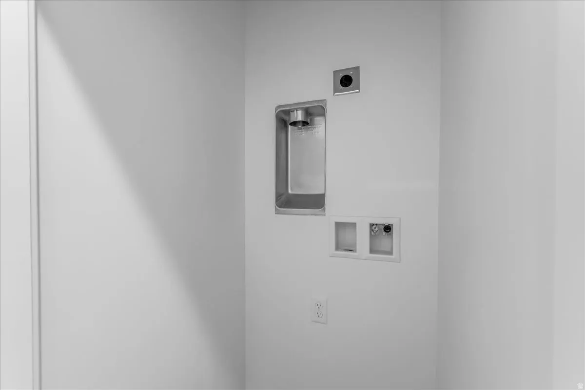 Laundry area featuring a recessed utility sink, washer hookups, dryer hookup, and power outlet