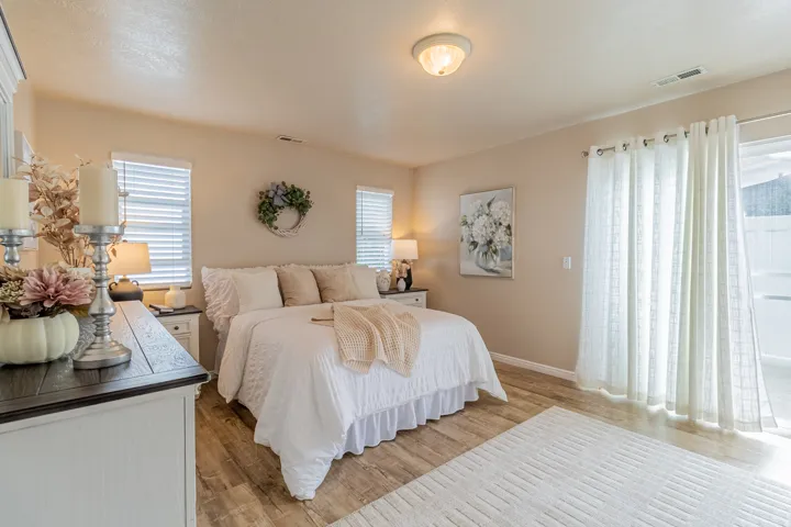 Wood-finish flooring, recessed ceiling light, dual windows with blinds, and sliding glass door