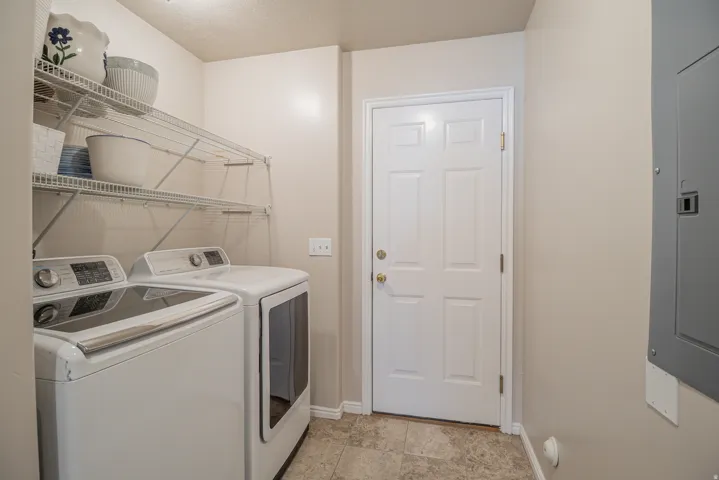 Utility space featuring wire shelving, a paneled door, and neutral wall paint