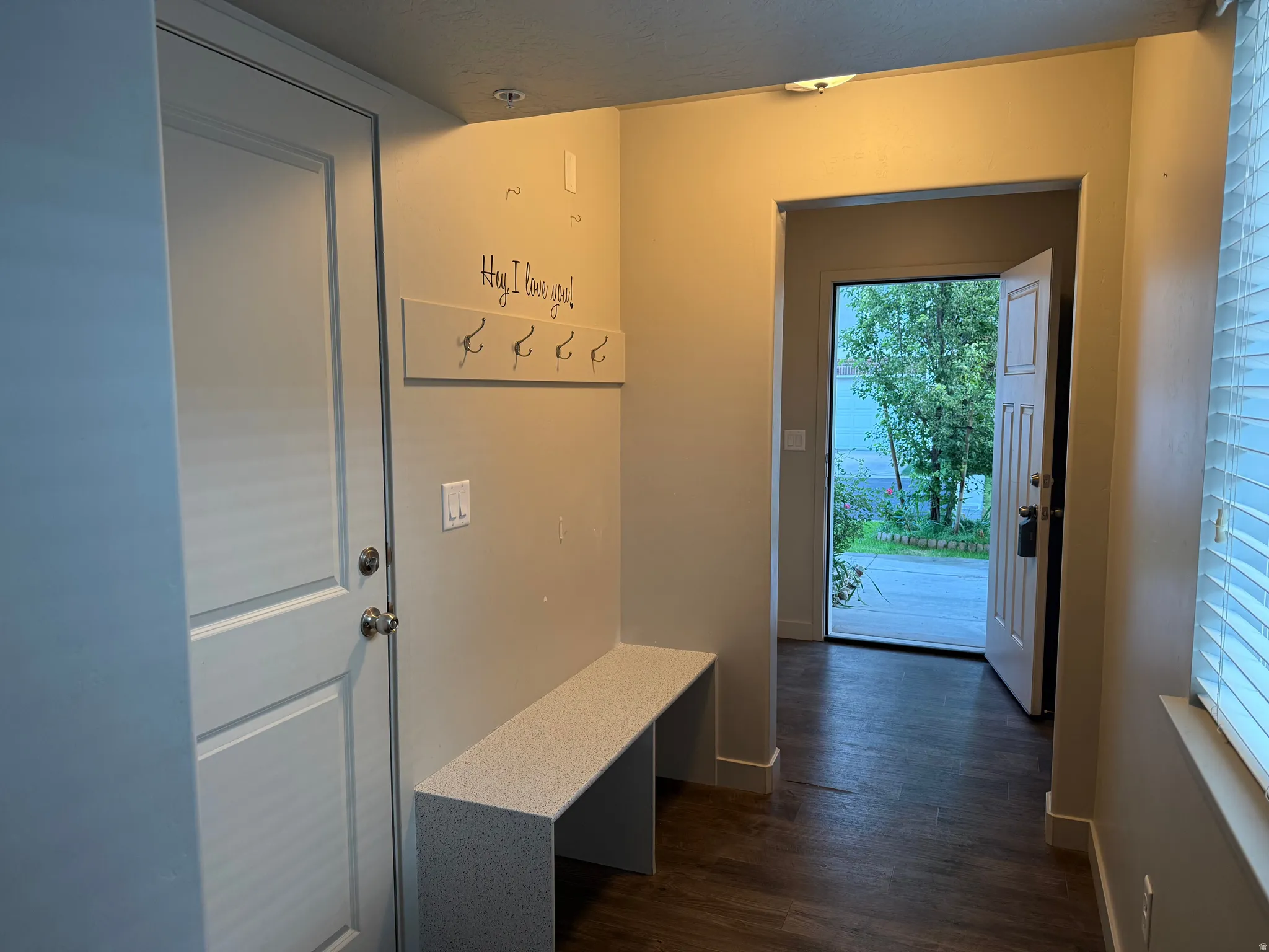 Built-in bench seating, recessed lighting, wood-finish flooring, and a window with blinds