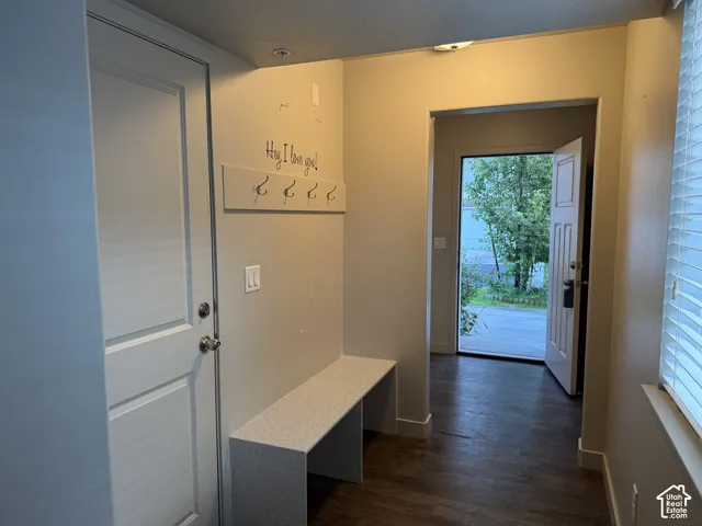 Built-in bench seating, recessed lighting, wood-finish flooring, and a window with blinds