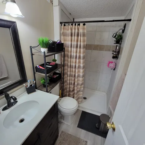 White vanity countertop with an integrated sink and dark bronze faucet