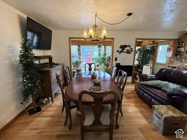 Hardwood flooring throughout, recessed lighting, and a built-in wooden sideboard
