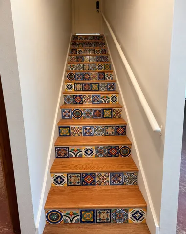 Tile and hardwood stairs to lower level