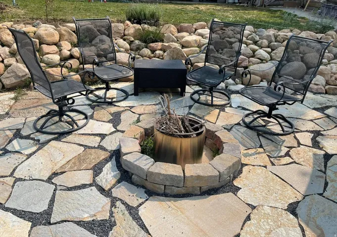 Stone patio area below upper backyard space