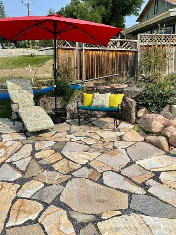 Stone patio area below upper backyard space
