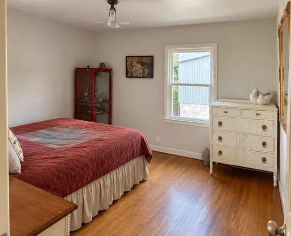 Bedroom on main with hardwood flooring