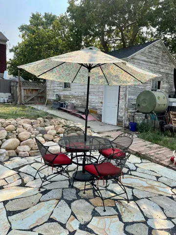 Stone patio area below upper backyard space