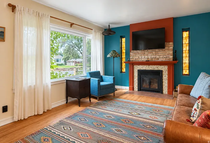 Light and bright living room with fireplace and hardwood floors