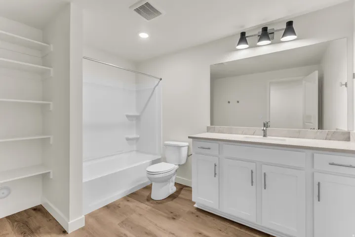 White shaker-style vanity with a light-toned countertop