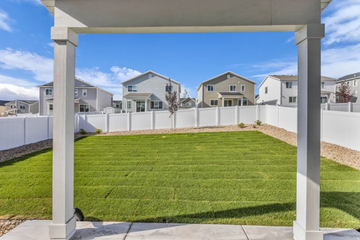 Expansive green lawn with a perimeter of gravel landscaping