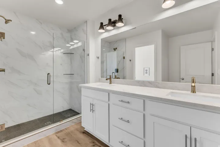 Dual vanity with white cabinetry and integrated sinks