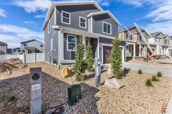 Two-story residence featuring horizontal siding, white trim, and a two-car garage