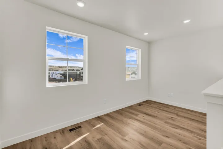 Wood-finish flooring, recessed lighting, and multiple windows
