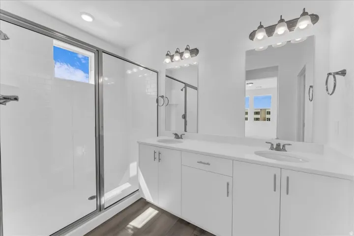 Dual sink vanity with white cabinetry and chrome hardware