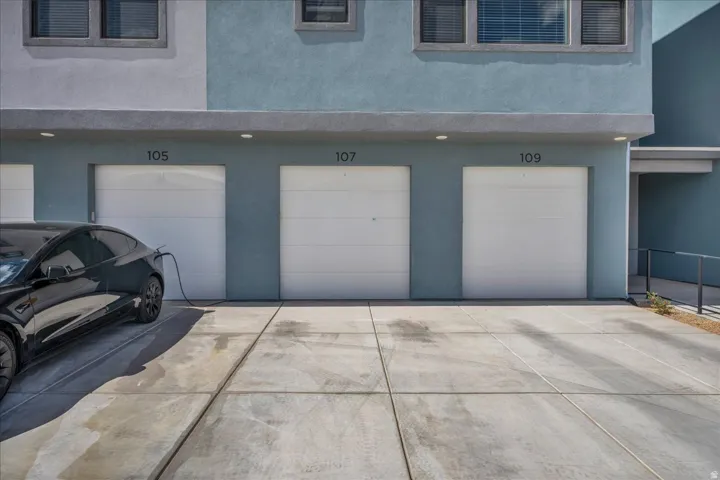 Three individual garages with white panel doors
