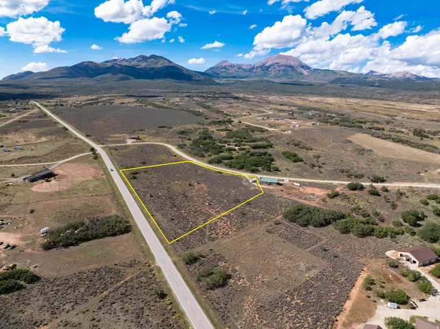 Expansive undeveloped land parcel with direct paved road frontage